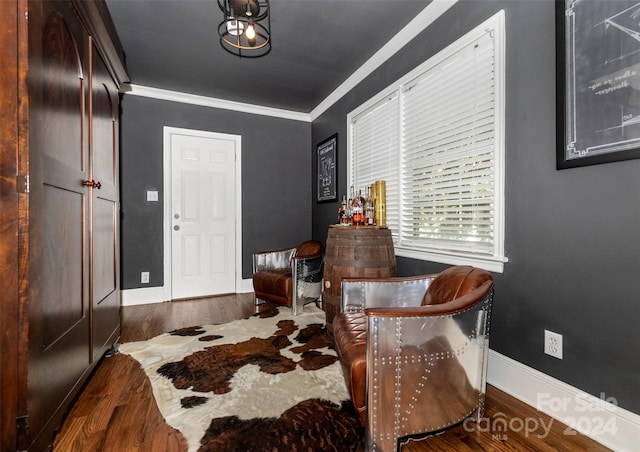 dining space featuring dark wood-type flooring and crown molding