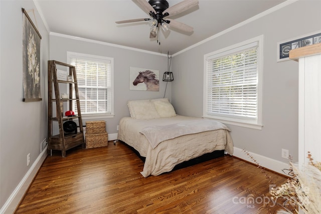 bedroom with crown molding, ceiling fan, and dark hardwood / wood-style floors