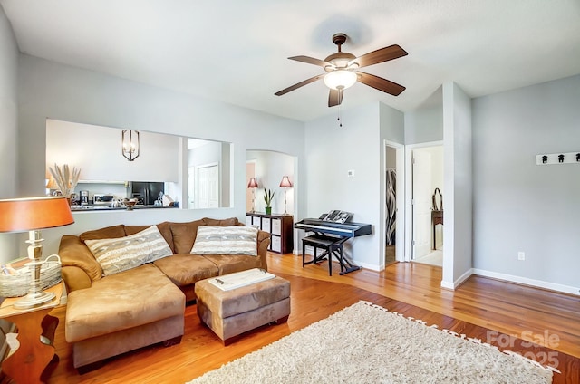 living room with ceiling fan and light hardwood / wood-style flooring