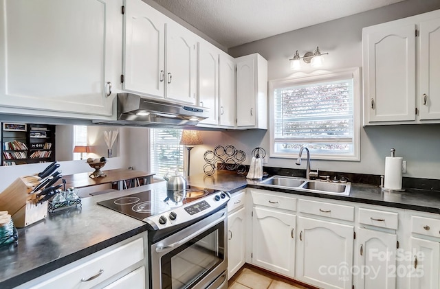 kitchen featuring stainless steel range with electric cooktop, sink, light tile patterned flooring, white cabinetry, and extractor fan