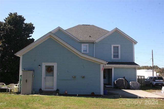 back of house featuring a patio and a yard