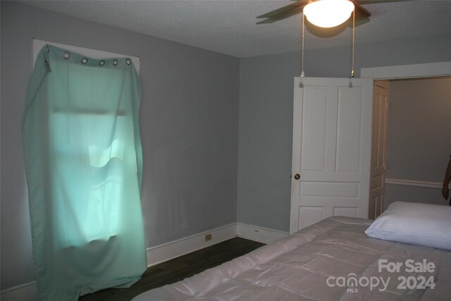 316 N Government St, Lincolnton, NC 28092 - bedroom featuring dark hardwood / wood-style flooring, a textured ceiling, and ceiling fan