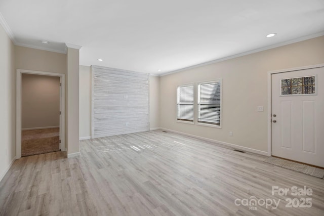 unfurnished living room with recessed lighting, crown molding, baseboards, and wood finished floors