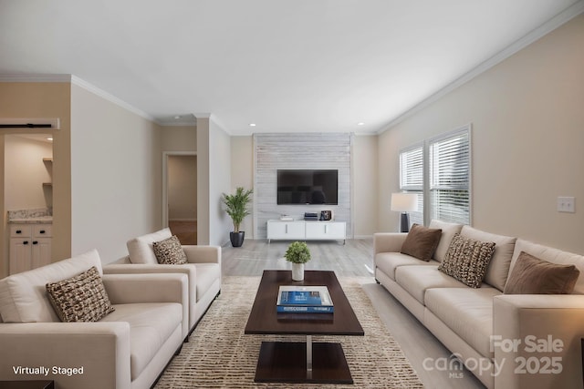 living area featuring light wood-type flooring, a barn door, crown molding, and recessed lighting