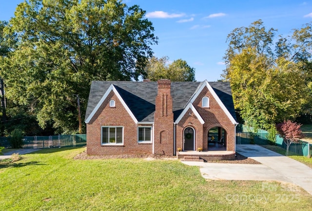 english style home with a front yard