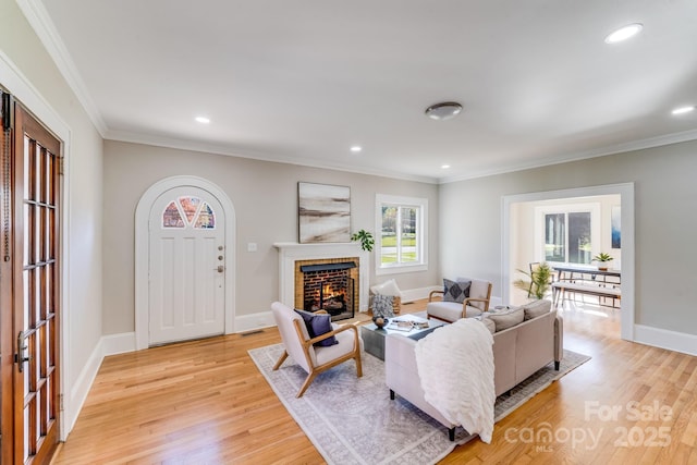 living room with light hardwood / wood-style flooring and crown molding