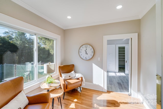 sitting room featuring hardwood / wood-style flooring and ornamental molding