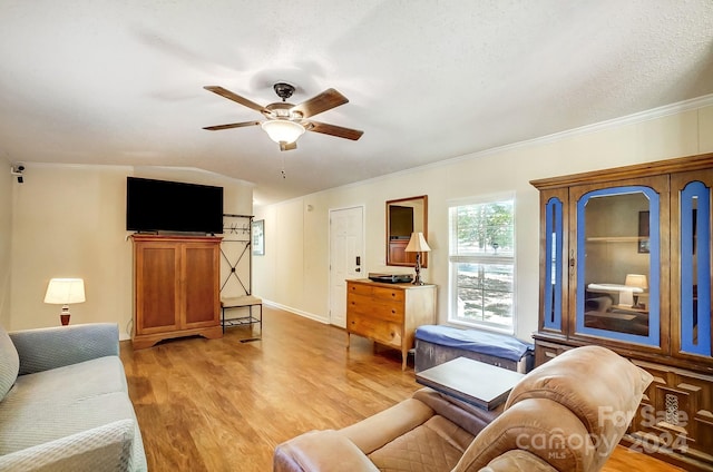 living room featuring a textured ceiling, light hardwood / wood-style floors, ceiling fan, lofted ceiling, and ornamental molding