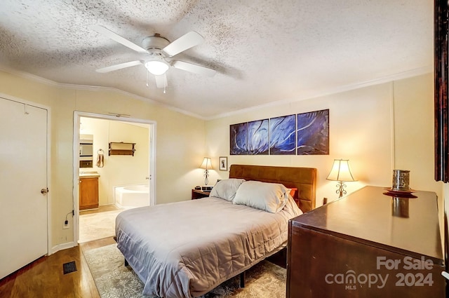 bedroom featuring a textured ceiling, ceiling fan, light hardwood / wood-style floors, vaulted ceiling, and ornamental molding