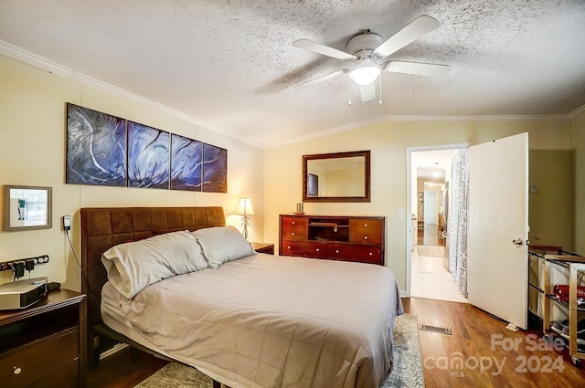 bedroom featuring ceiling fan, a textured ceiling, wood-type flooring, and lofted ceiling