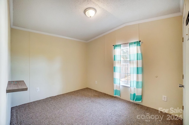 spare room featuring lofted ceiling, carpet, crown molding, and a textured ceiling