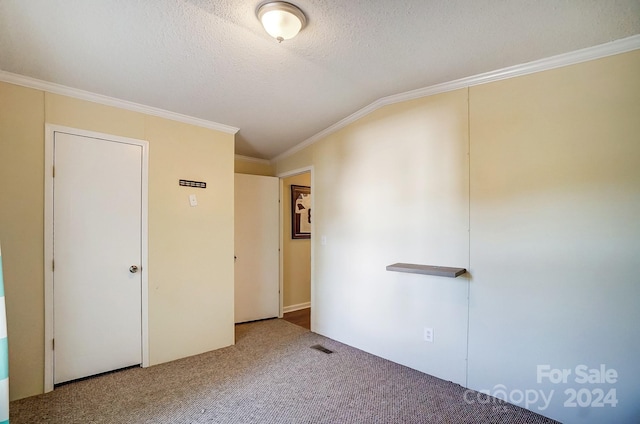 unfurnished bedroom with crown molding, a textured ceiling, carpet, and lofted ceiling