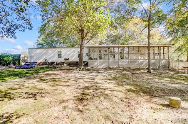 back of house featuring a sunroom