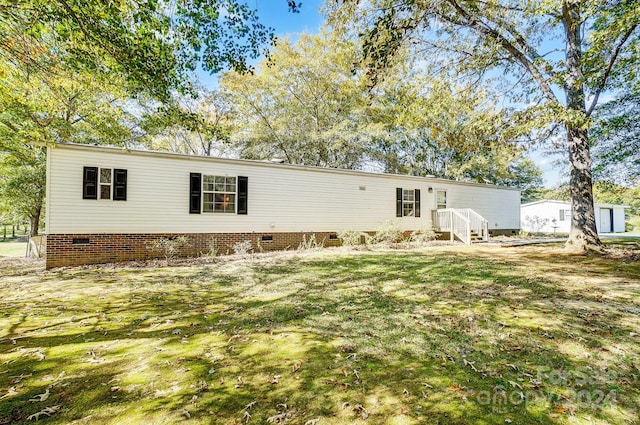 back of house with a lawn