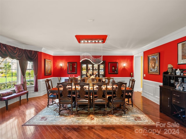 dining room featuring hardwood / wood-style floors and crown molding