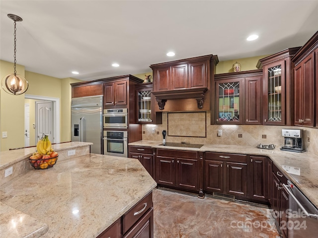 kitchen with light stone countertops, tasteful backsplash, stainless steel appliances, decorative light fixtures, and an inviting chandelier