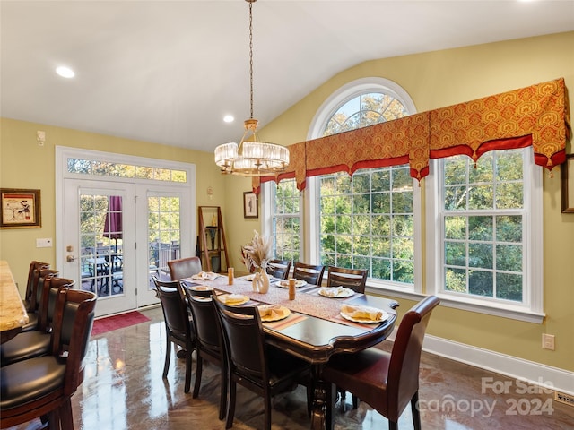 dining room with a notable chandelier and lofted ceiling