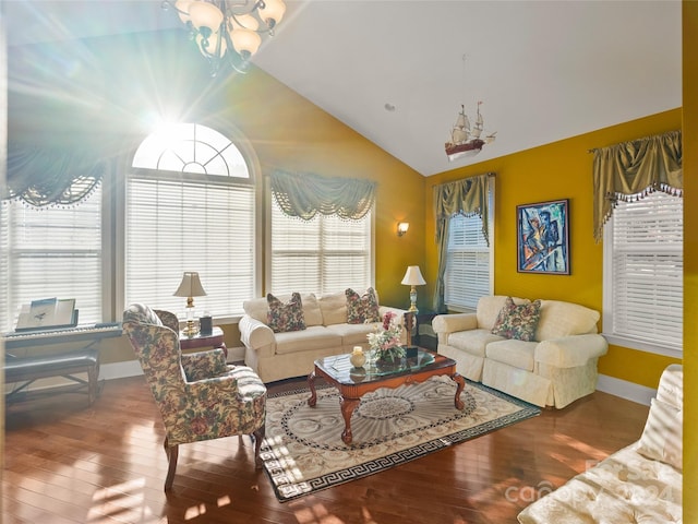 living room featuring hardwood / wood-style floors, an inviting chandelier, and vaulted ceiling