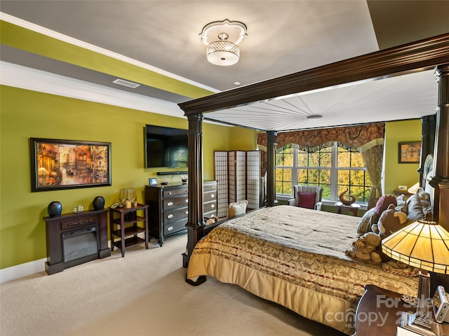 bedroom with crown molding and light carpet