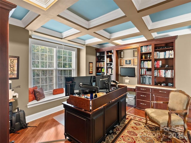 office space with crown molding, light hardwood / wood-style floors, and coffered ceiling