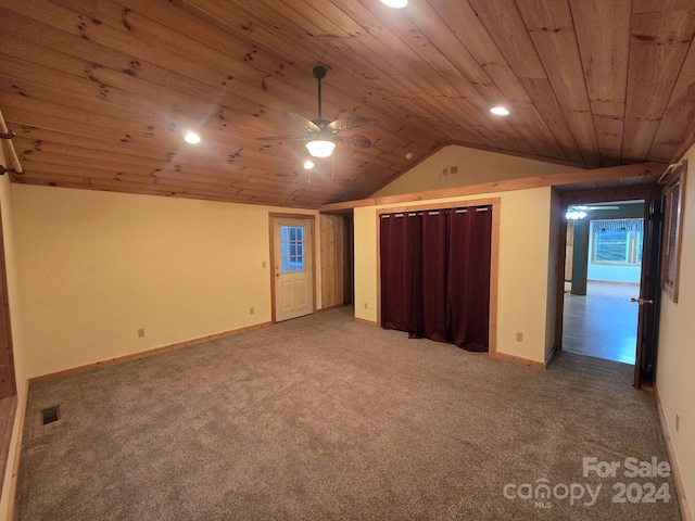 interior space featuring ceiling fan, wood ceiling, carpet flooring, and vaulted ceiling