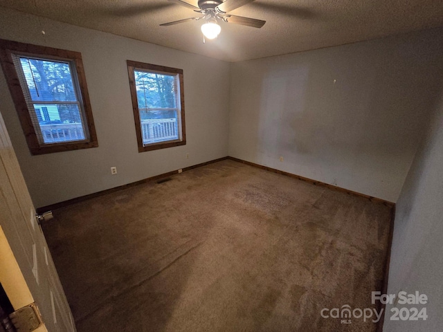 unfurnished room featuring carpet, a textured ceiling, and ceiling fan