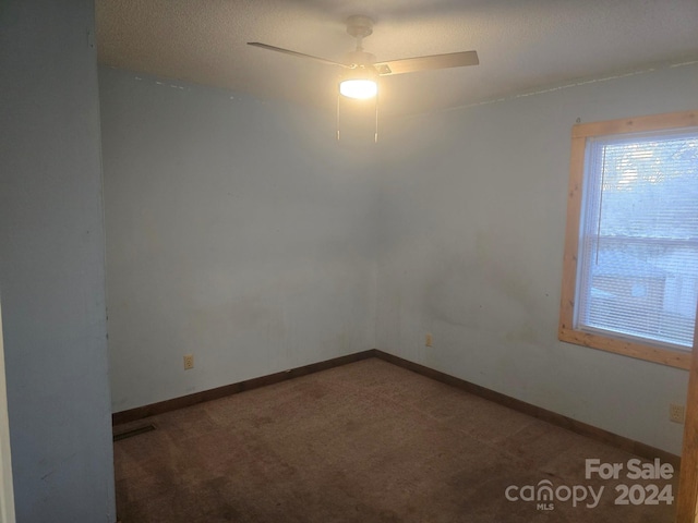 empty room with carpet flooring and ceiling fan