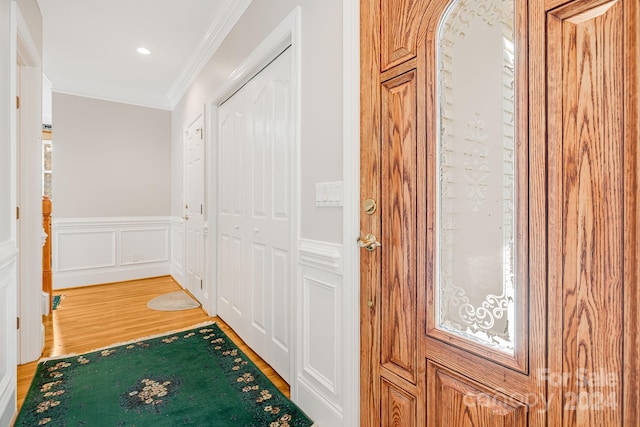 corridor with crown molding and hardwood / wood-style flooring