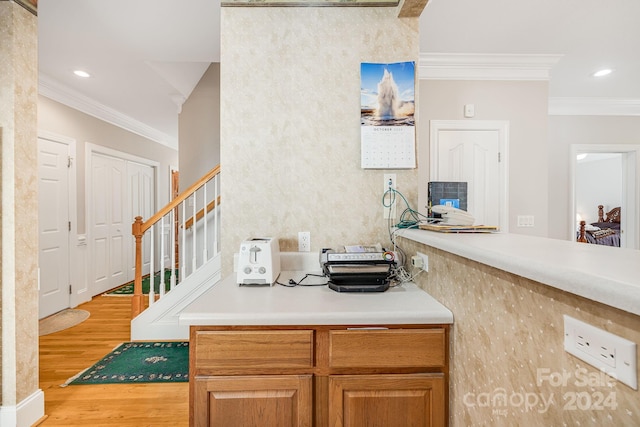 kitchen with ornamental molding and light hardwood / wood-style flooring