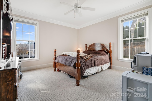 carpeted bedroom with ceiling fan and crown molding