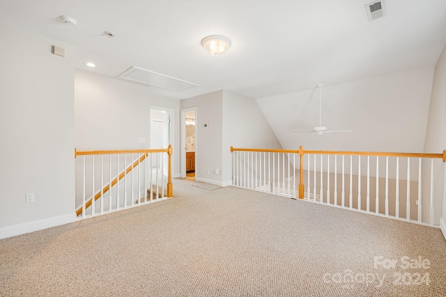 additional living space with light colored carpet, vaulted ceiling, and ceiling fan