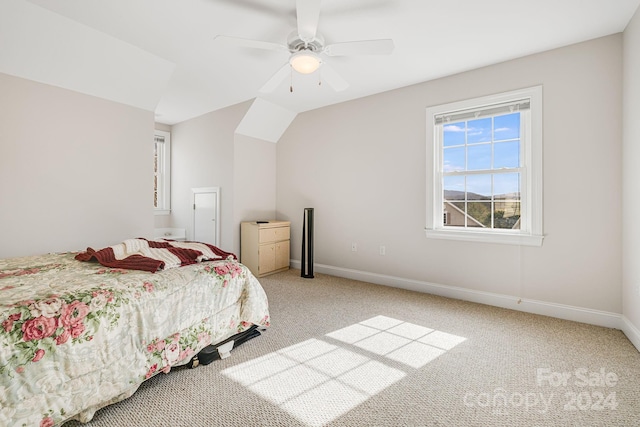 carpeted bedroom featuring lofted ceiling and ceiling fan