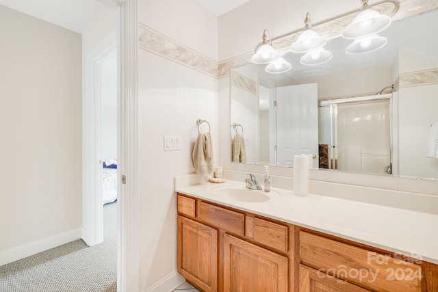 bathroom featuring vanity, tile patterned floors, and a shower with shower door