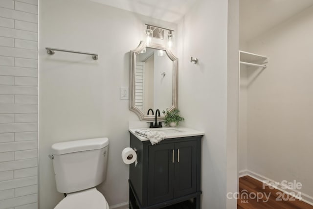 bathroom with vanity, hardwood / wood-style floors, and toilet