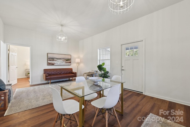 dining space with a notable chandelier and wood-type flooring