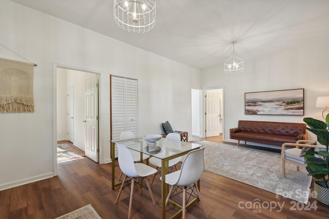 dining room featuring dark hardwood / wood-style floors and a chandelier