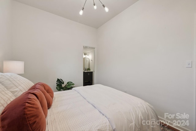 bedroom with vaulted ceiling and ensuite bathroom