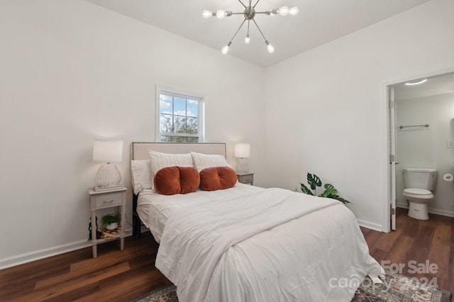 bedroom featuring ensuite bath, a chandelier, and dark hardwood / wood-style flooring