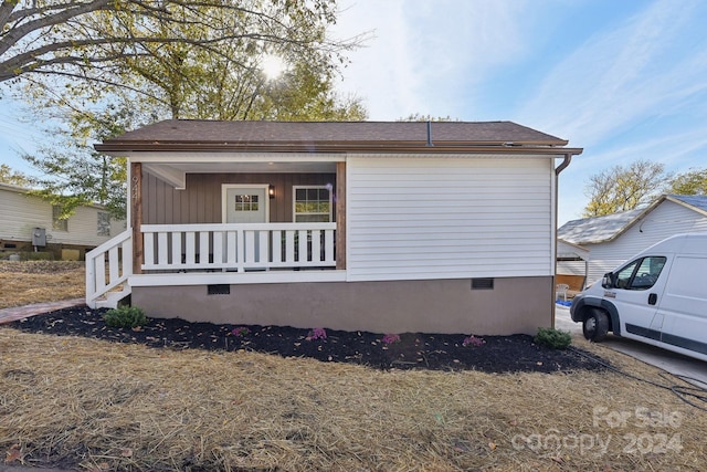 view of side of home with covered porch