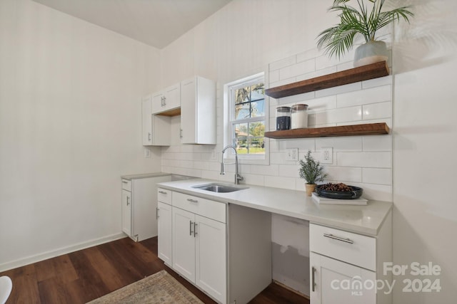 kitchen featuring tasteful backsplash, sink, dark hardwood / wood-style floors, and white cabinets