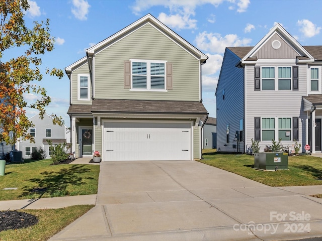 view of front of property featuring a front yard, central AC unit, and a garage