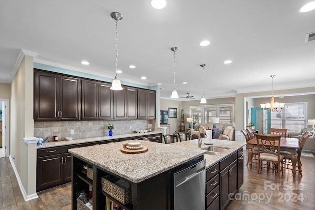 kitchen with dishwasher, an island with sink, sink, decorative light fixtures, and dark hardwood / wood-style flooring