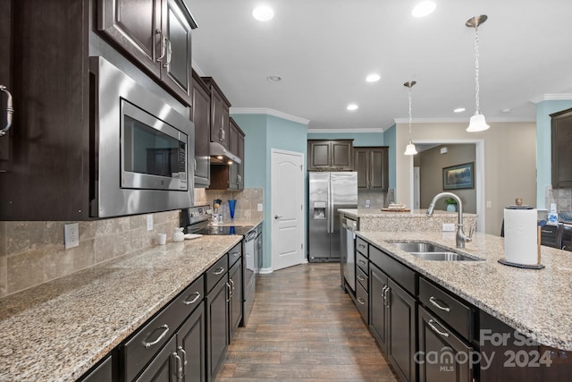 kitchen with appliances with stainless steel finishes, ornamental molding, sink, dark wood-type flooring, and decorative light fixtures