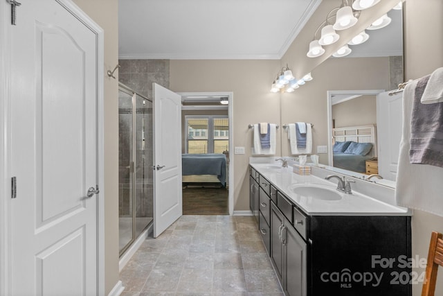 bathroom with vanity, an enclosed shower, and crown molding