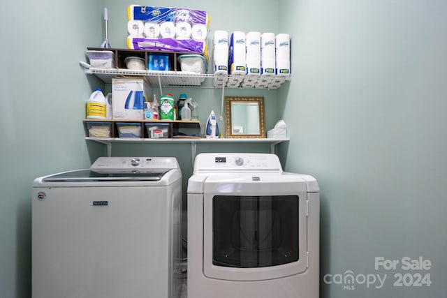 clothes washing area featuring washer and clothes dryer