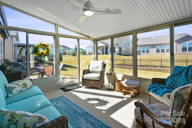 sunroom featuring ceiling fan, lofted ceiling, and a wealth of natural light