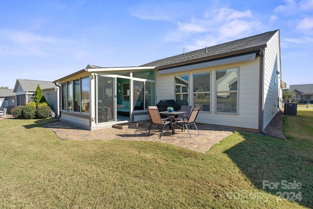 rear view of property with a patio, central AC, a sunroom, and a lawn