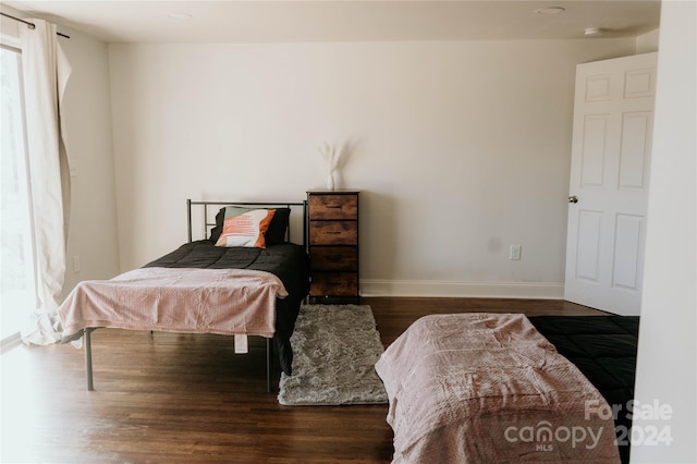 bedroom with dark wood-type flooring