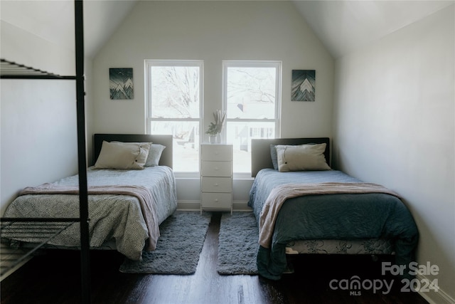 bedroom with high vaulted ceiling, multiple windows, and hardwood / wood-style floors