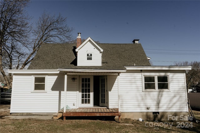 back of house with a deck